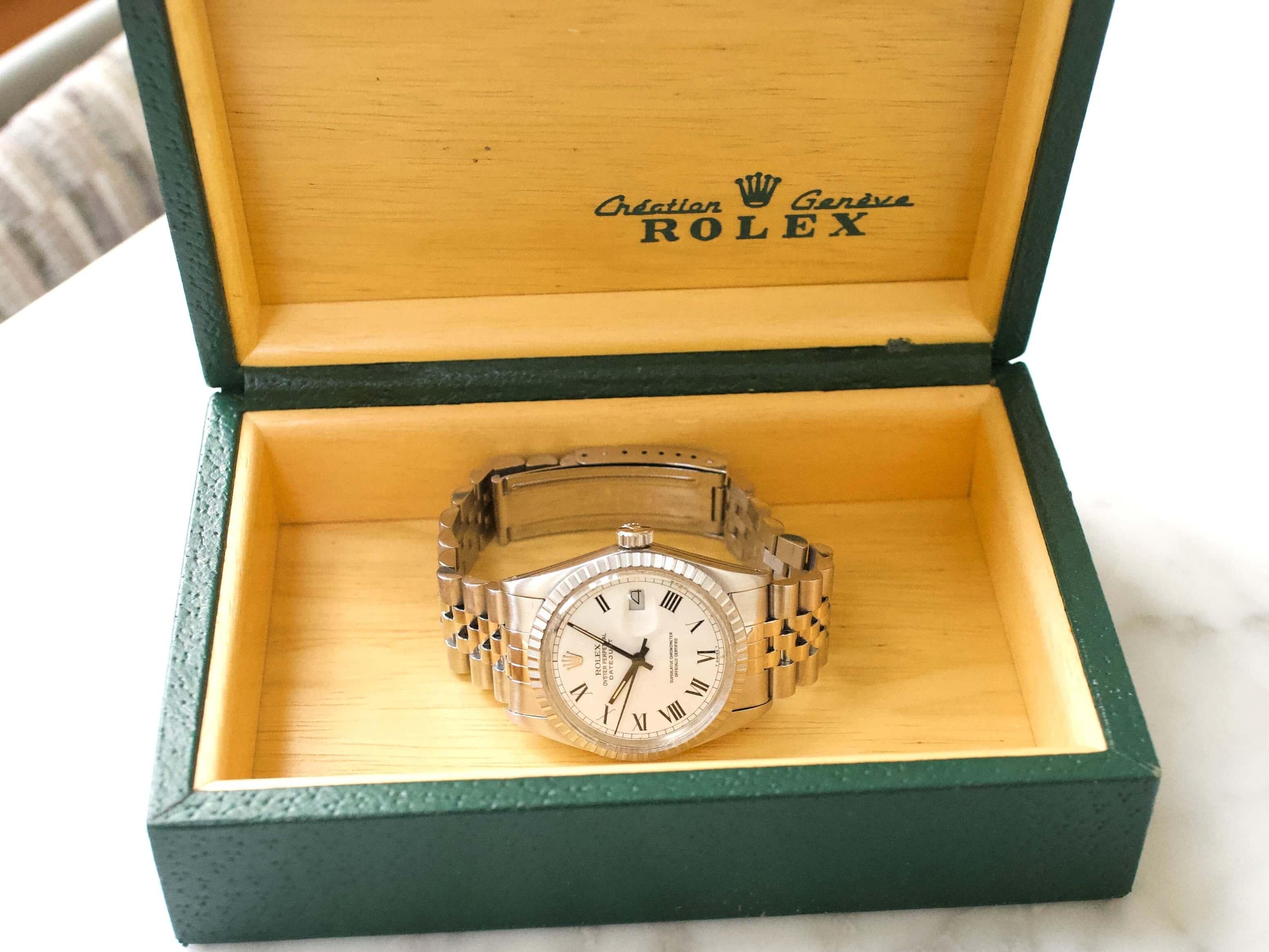Silver luxury Swiss watch with Roman numeral dial in green and yellow presentation box