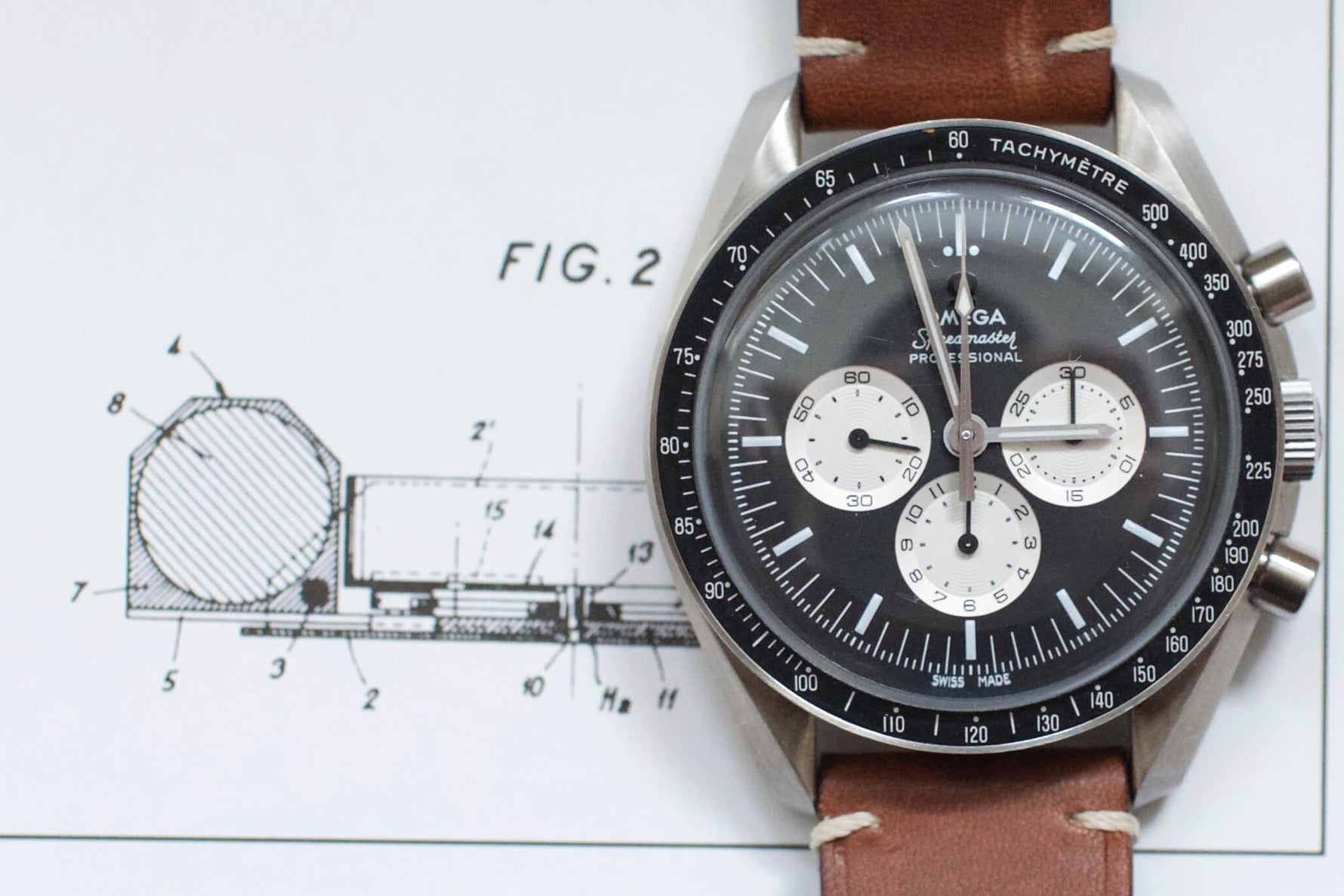 Omega Speedmaster Professional chronograph watch with brown leather strap on technical drawing background