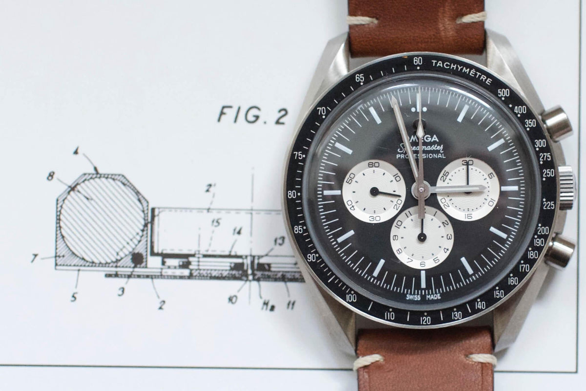 Omega Speedmaster Professional chronograph watch with brown leather strap on technical drawing background