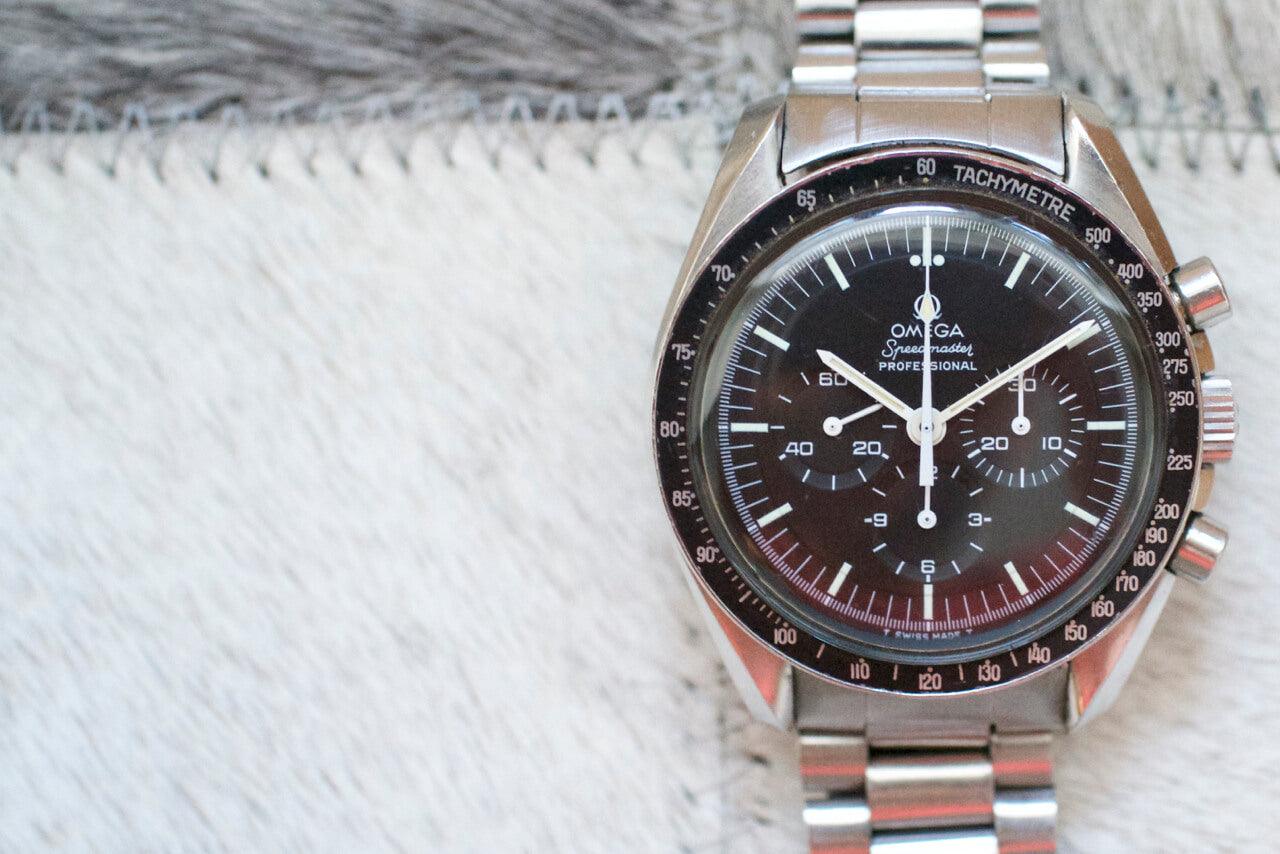 Omega Speedmaster Professional chronograph watch with black dial and stainless steel bracelet