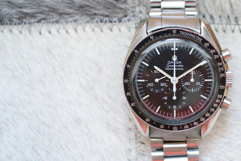 Omega Speedmaster Professional chronograph watch with black dial and stainless steel bracelet