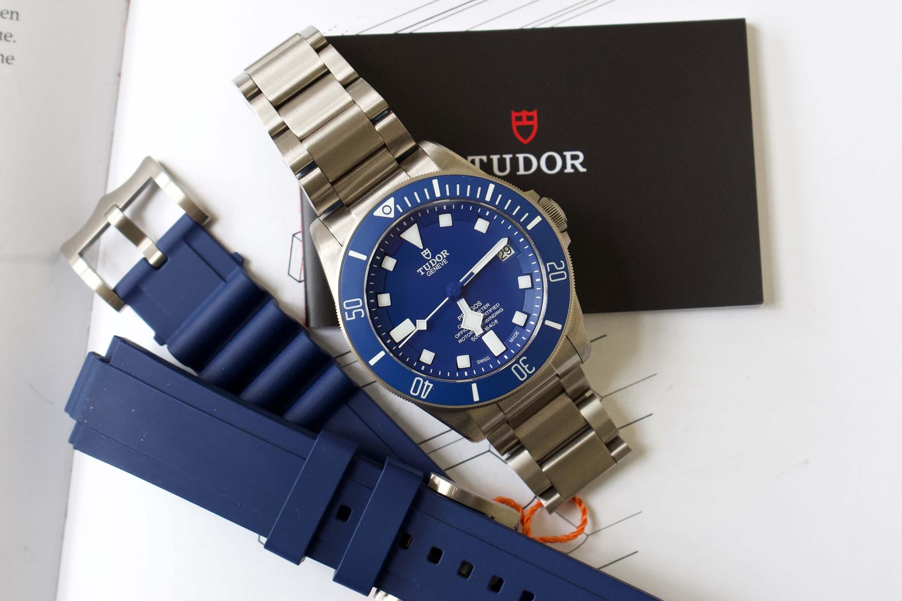 Blue dial Tudor dive watch with stainless steel bracelet and extra blue rubber strap