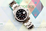 Rolex GMT-Master II luxury watch with black dial and bidirectional bezel on warranty card