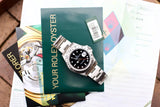 Rolex Explorer watch with official green box, warranty card, and documentation.