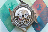 Detailed view of a luxury Swiss watch movement inside its stainless steel case