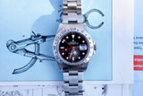 Rolex Explorer II luxury watch with black dial and steel bracelet on a technical drawing
