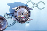 Internal mechanical movement of a luxury Swiss watch during repair.