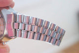 Close-up of a silver luxury watch with a stainless steel jubilee style bracelet