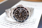 Stainless steel luxury Swiss dive watch with black bezel and bracelet, close-up view
