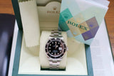 Stainless steel luxury dive watch with black dial in presentation box, certification card visible