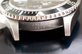Close-up of stainless steel luxury watch case with engraved model number 16610T.