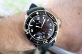 Close-up of Blancpain Fifty Fathoms diving watch with black dial and bezel on wrist