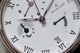 Close-up of luxury Swiss-made watch with Roman numerals, subdials, and date window