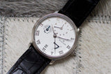 Luxury Swiss dress watch with white dial, Roman numerals, subdials, and black leather strap