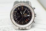 Close-up of a luxury stainless steel chronograph watch with black dial and multiple subdials