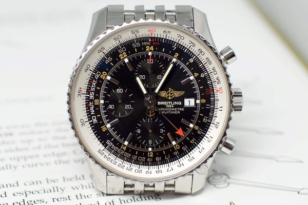 Close-up of a luxury stainless steel chronograph watch with black dial and multiple subdials