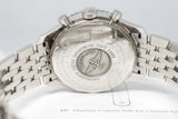 Close-up of a stainless steel chronograph watch case back with engraved details and metal bracelet