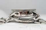 Close-up side view of a stainless steel chronograph luxury watch with visible crown and pushers
