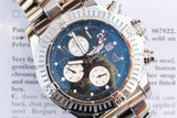 Close-up of a Breitling luxury chronograph watch with a blue dial and steel bracelet.