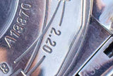 Close-up of a luxury watch movement with engraved serial number A13370 and 2.20 markings