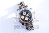 Stainless steel luxury chronograph watch with a blue dial resting on a document.