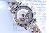 Close-up of the open back movement of a Breitling luxury Swiss watch with steel bracelet.