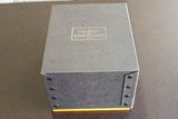 Breitling luxury watch box with logo and metallic studs on a brown surface
