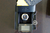 Luxury stainless steel dive watch with black dial in box, warranty card, and papers included