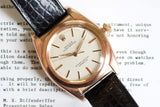 Vintage rose gold bubble back Swiss watch with cream dial and black leather strap