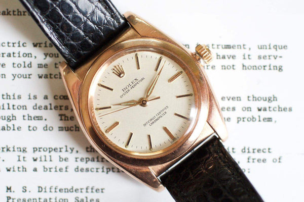 Vintage rose gold bubble back Swiss watch with cream dial and black leather strap