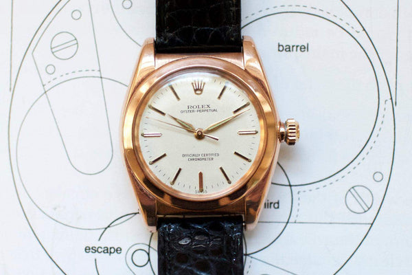 Vintage rose gold Oyster Perpetual watch with cream dial and black leather strap