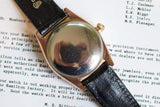 Vintage 14k rose gold Bubbleback Oyster Perpetual watch with black leather strap, case back view