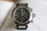 Stainless steel chronograph luxury watch with black dial and bold numerals on a display stand