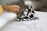Stainless steel chronograph luxury watch with metal bracelet lying on a technical sketch