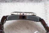 Side view of a luxury ceramic and stainless steel women's watch with a ridged bezel