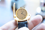 Close-up of a gold Ebel luxury Swiss watch with a black leather strap