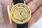 Close-up of a vintage gold Ebel Swiss watch with a black leather strap.