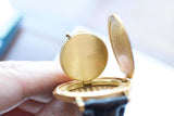 Close-up of the gold case back and inner lid of a luxury Swiss watch