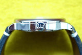 Side profile of a luxury stainless steel watch with a blue leather strap.