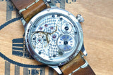 Back view of an Eberhard & Co. luxury Swiss watch movement with a brown leather strap.