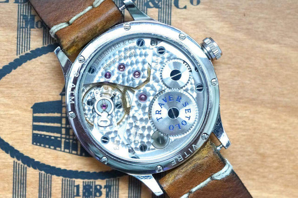 Back view of an Eberhard & Co. luxury Swiss watch movement with a brown leather strap.