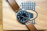Eberhard & Co luxury watch with brown leather strap on a branded wooden box