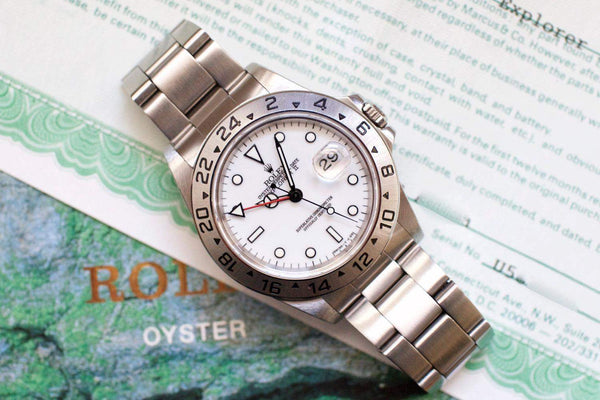 Rolex Oyster Perpetual Date luxury watch with silver dial and steel bracelet on document