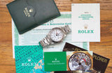 Rolex Explorer watch with original box, papers, and factory service booklet.