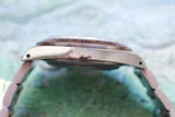 Side profile view of a luxury silver wristwatch with a rotating bezel and metal bracelet.