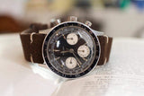 Vintage Gallet chronograph luxury watch with brown suede strap on open book