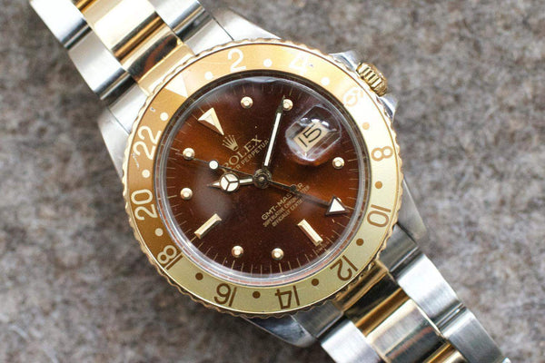 Rolex GMT-Master luxury watch with brown bezel and two-tone gold and steel bracelet