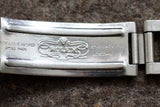 Close-up of a stainless steel Rolex watch clasp with engraved markings and logo.