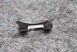 Close-up of a stainless steel luxury watch bracelet link with '401 B' engraving
