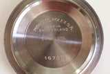 Close-up of the stainless steel case back of a Rolex watch with model number 16750.